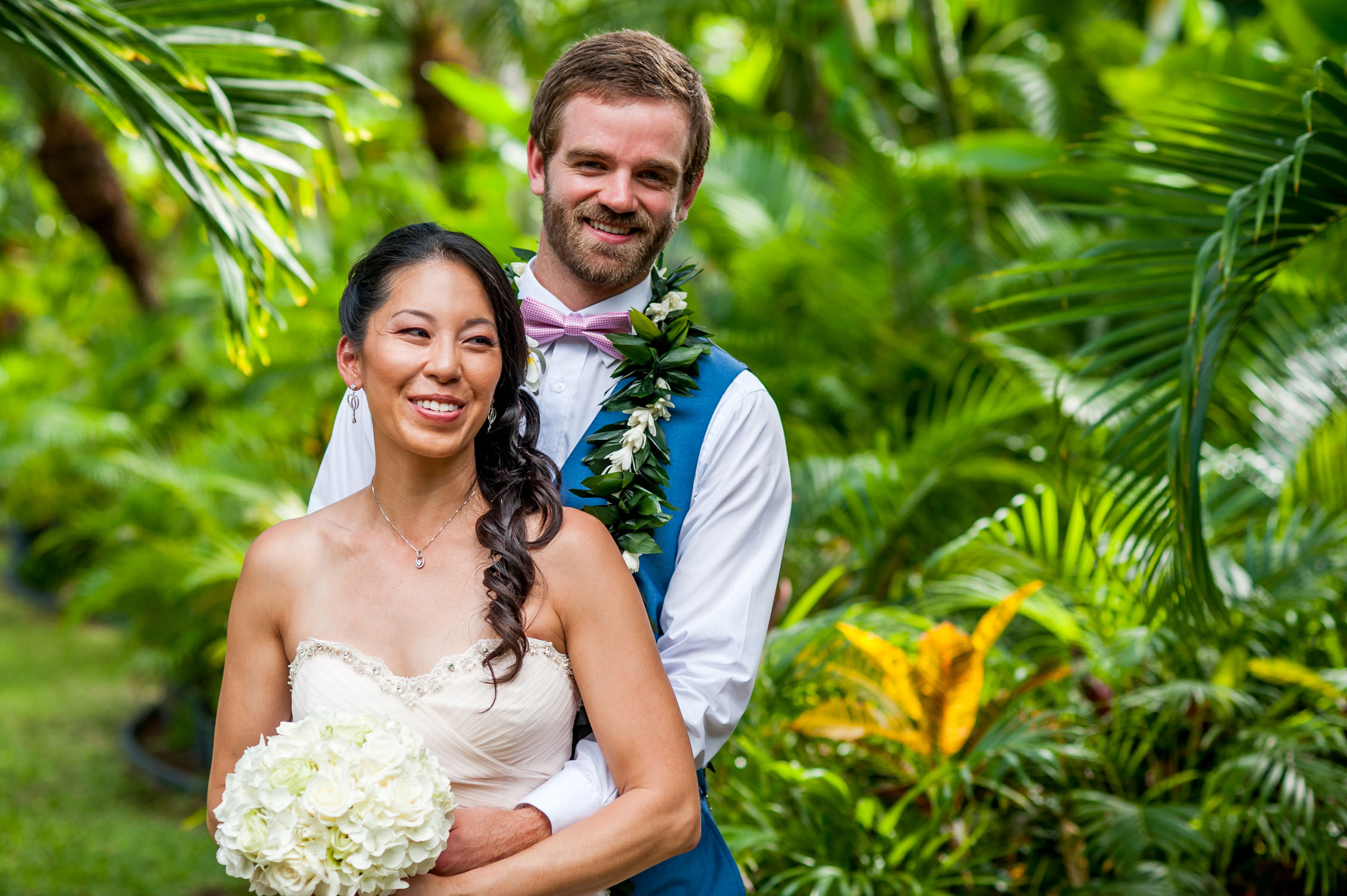 wedding couple embracing in hawaii lush greenery